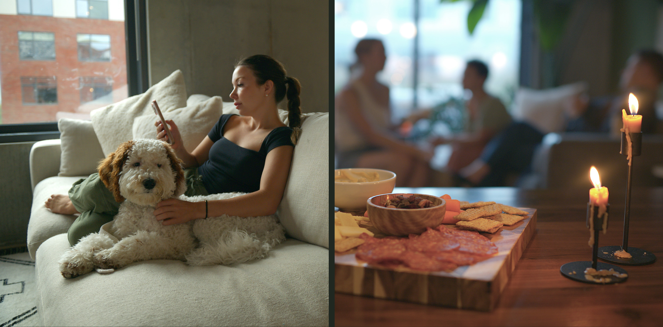 A woman sits on a sofa with a fluffy dog, using her phone. Next to her, a table with snacks and lit candles is shown, while three people talk in the blurred background.