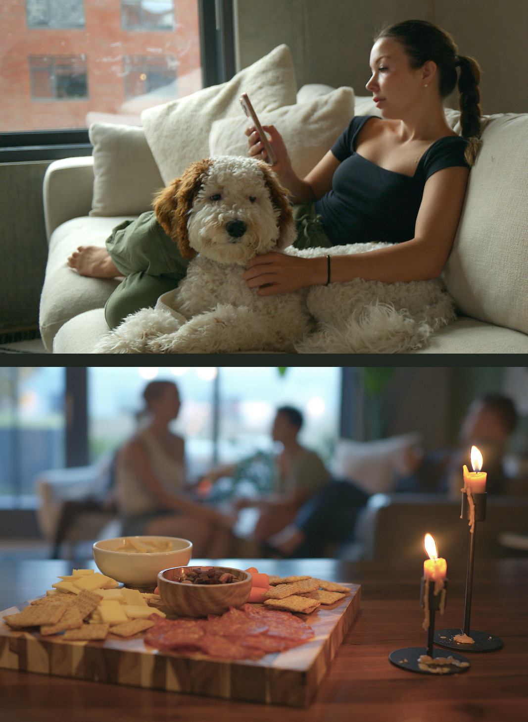 A woman lounges on a sofa with a fluffy dog, looking at her phone. Below, a candlelit charcuterie board with cheeses, meats, and crackers is on a table, with blurred people in the background.